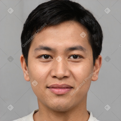 Joyful asian young-adult male with short  black hair and brown eyes