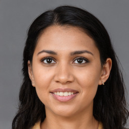 Joyful latino young-adult female with long  brown hair and brown eyes