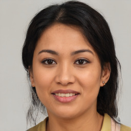 Joyful latino young-adult female with medium  brown hair and brown eyes