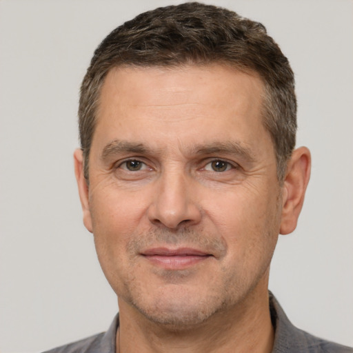 Joyful white adult male with short  brown hair and brown eyes