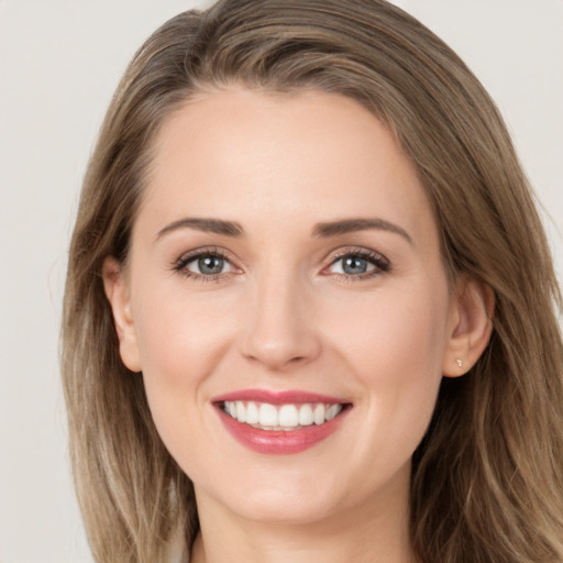 Joyful white young-adult female with long  brown hair and grey eyes