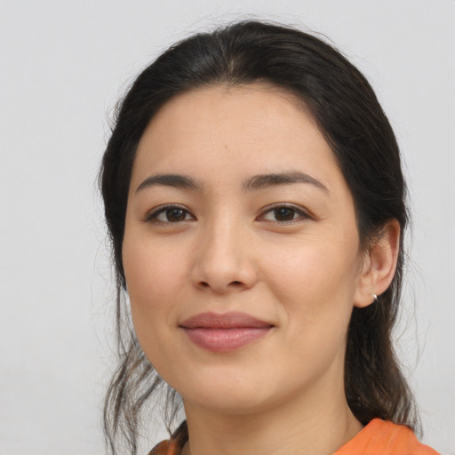 Joyful latino young-adult female with medium  black hair and brown eyes