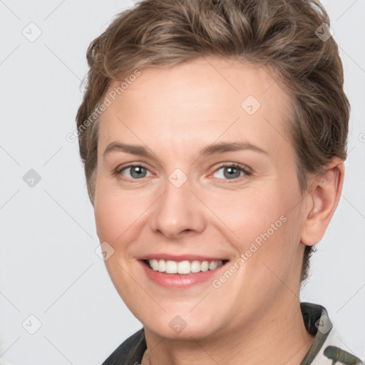 Joyful white young-adult female with short  brown hair and grey eyes