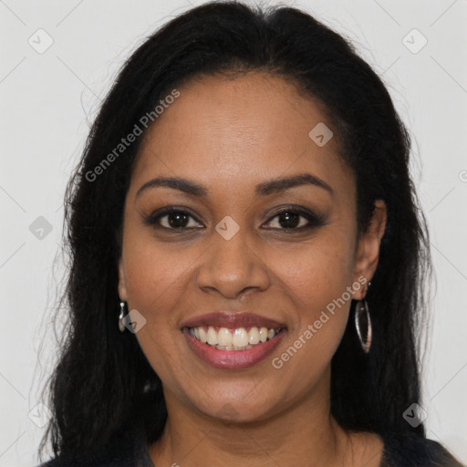 Joyful black young-adult female with long  brown hair and brown eyes