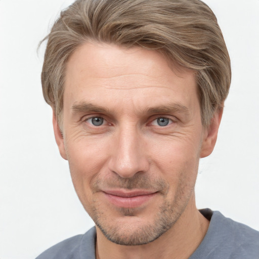 Joyful white adult male with short  brown hair and grey eyes