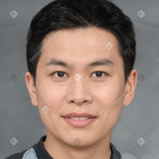 Joyful asian young-adult male with short  brown hair and brown eyes