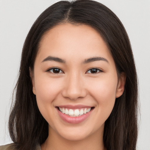 Joyful white young-adult female with long  brown hair and brown eyes