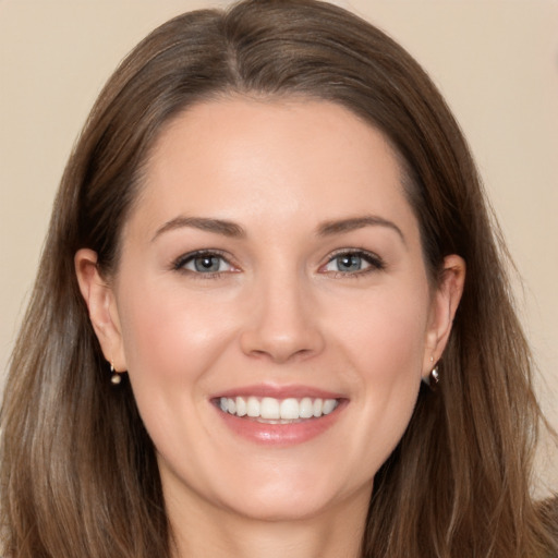 Joyful white young-adult female with long  brown hair and brown eyes