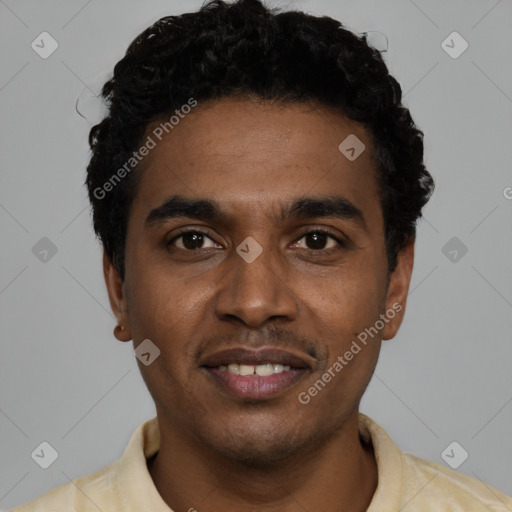 Joyful black young-adult male with short  black hair and brown eyes