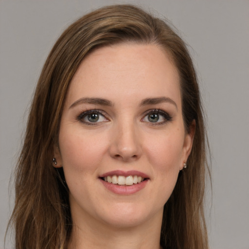 Joyful white young-adult female with long  brown hair and green eyes