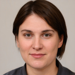 Joyful white young-adult female with medium  brown hair and brown eyes