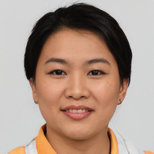 Joyful asian young-adult female with short  brown hair and brown eyes