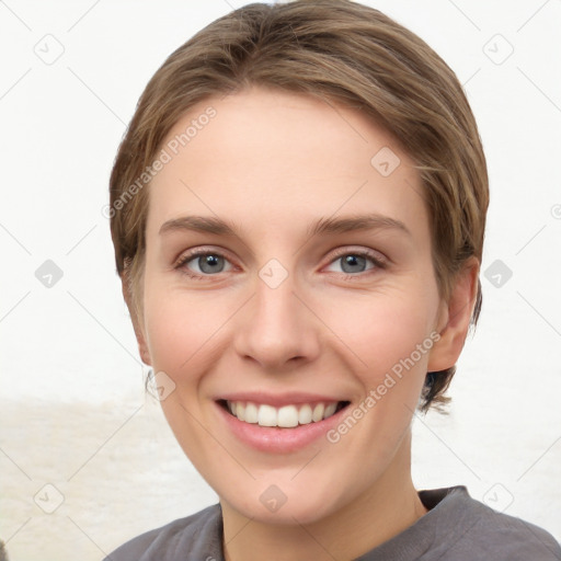 Joyful white young-adult female with medium  brown hair and grey eyes