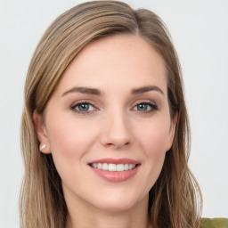 Joyful white young-adult female with long  brown hair and green eyes