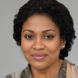 Joyful black young-adult female with long  brown hair and brown eyes