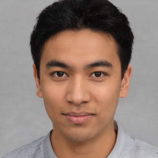 Joyful asian young-adult male with short  black hair and brown eyes