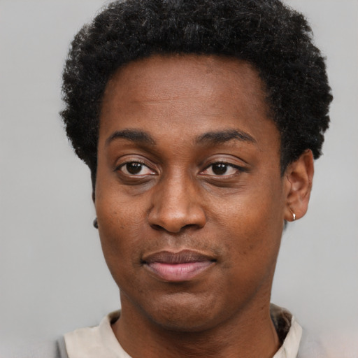 Joyful black young-adult female with short  black hair and brown eyes