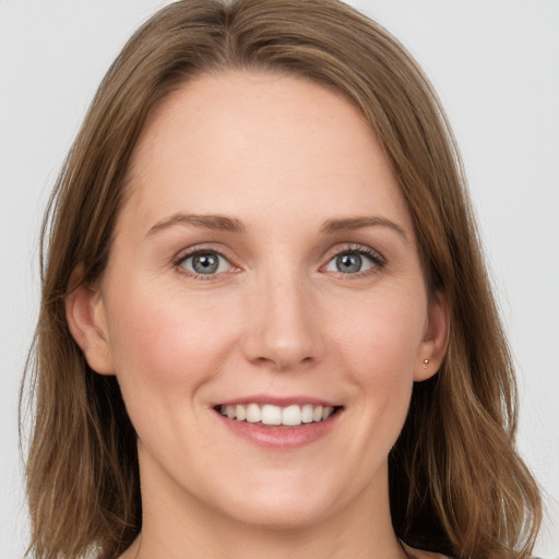 Joyful white young-adult female with long  brown hair and grey eyes