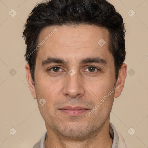 Joyful white adult male with short  black hair and brown eyes