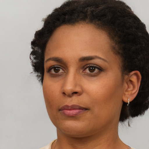Neutral black young-adult female with short  brown hair and brown eyes