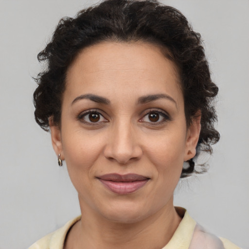 Joyful latino adult female with short  brown hair and brown eyes