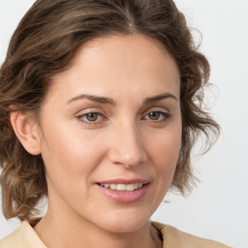 Joyful white young-adult female with medium  brown hair and green eyes