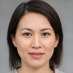 Joyful white young-adult female with medium  brown hair and brown eyes