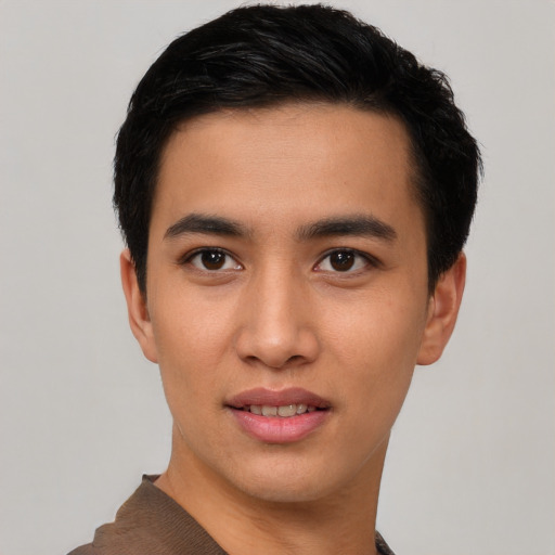 Joyful asian young-adult male with short  black hair and brown eyes