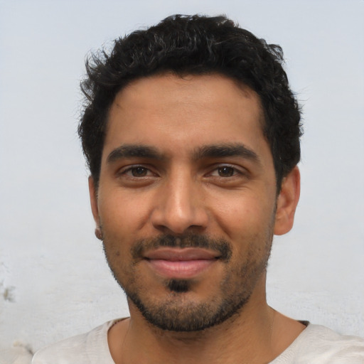 Joyful latino young-adult male with short  black hair and brown eyes