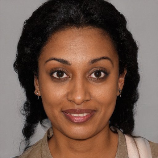 Joyful black young-adult female with medium  brown hair and brown eyes
