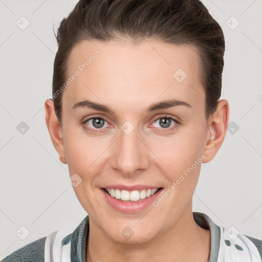 Joyful white young-adult female with short  brown hair and grey eyes