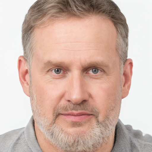 Joyful white adult male with short  brown hair and grey eyes