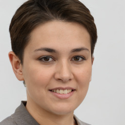 Joyful white young-adult female with short  brown hair and grey eyes