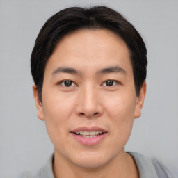 Joyful asian young-adult male with short  brown hair and brown eyes