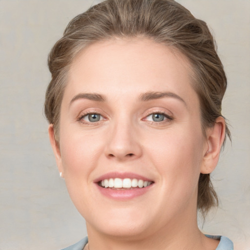 Joyful white young-adult female with medium  brown hair and blue eyes