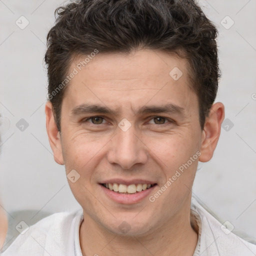 Joyful white adult male with short  brown hair and brown eyes