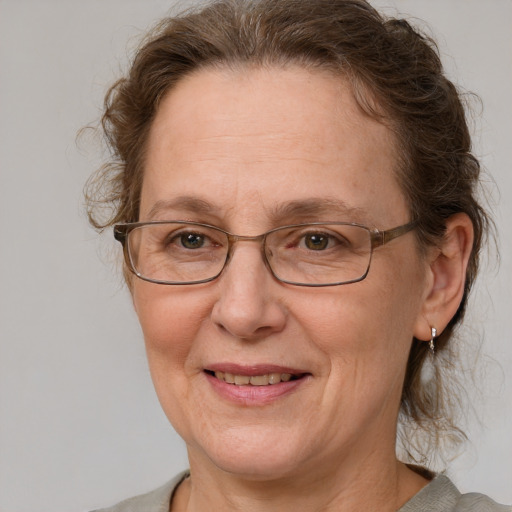 Joyful white middle-aged female with medium  brown hair and blue eyes