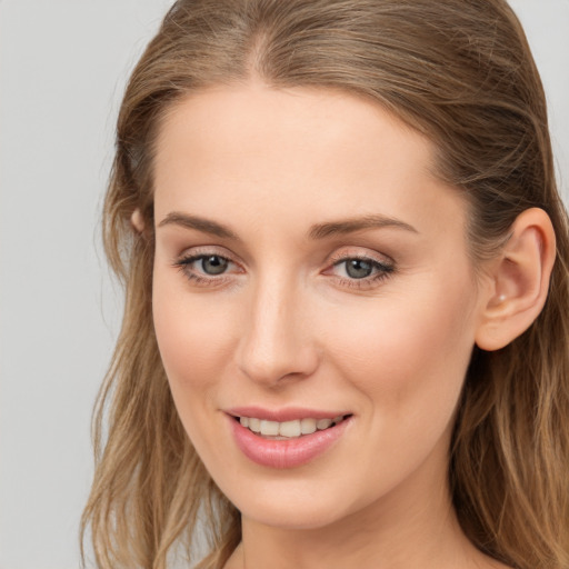 Joyful white young-adult female with long  brown hair and grey eyes