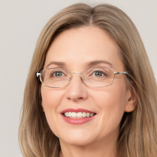 Joyful white adult female with long  brown hair and grey eyes