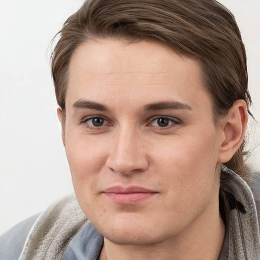 Joyful white young-adult female with short  brown hair and grey eyes