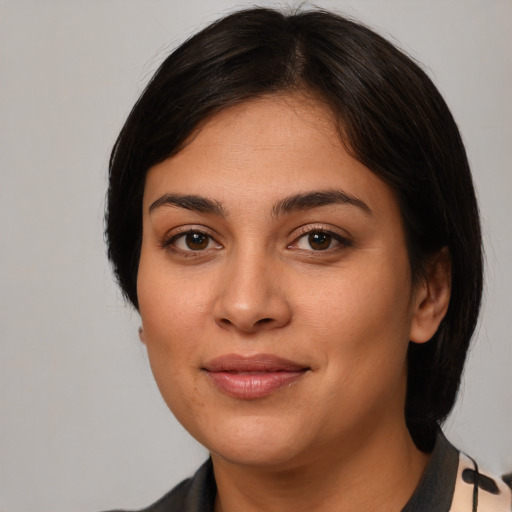 Joyful latino young-adult female with medium  brown hair and brown eyes