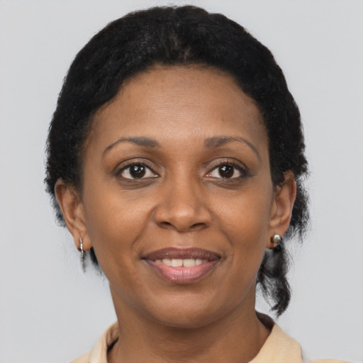 Joyful black adult female with short  brown hair and brown eyes