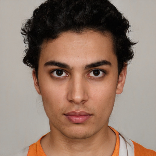 Neutral latino young-adult male with short  brown hair and brown eyes