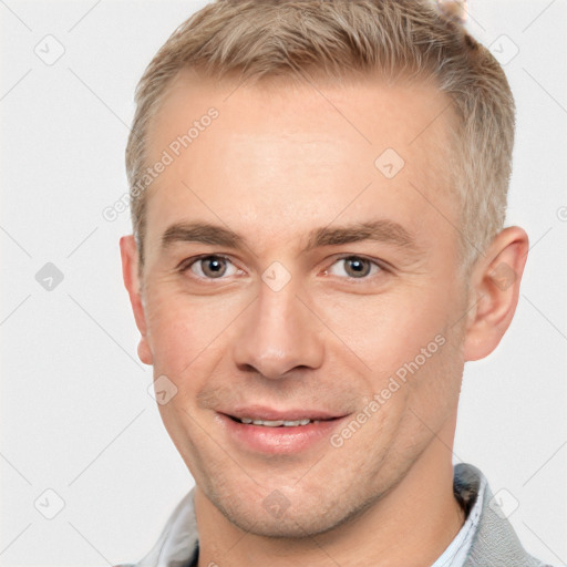 Joyful white adult male with short  brown hair and grey eyes