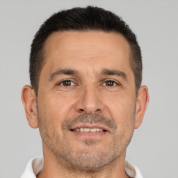 Joyful white adult male with short  brown hair and brown eyes