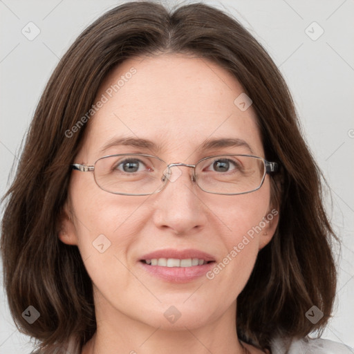 Joyful white adult female with medium  brown hair and grey eyes