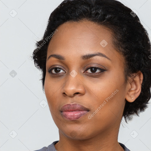 Joyful black young-adult female with long  black hair and brown eyes