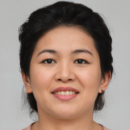 Joyful asian young-adult female with medium  black hair and brown eyes