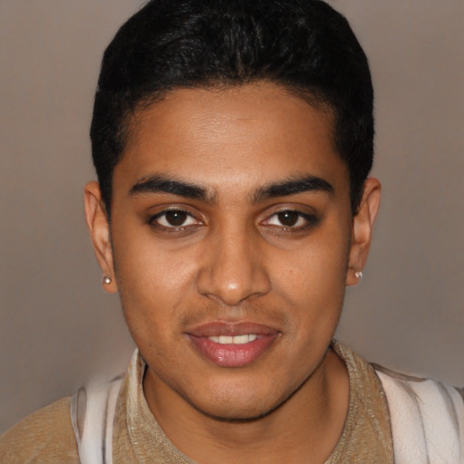 Joyful black young-adult male with short  brown hair and brown eyes