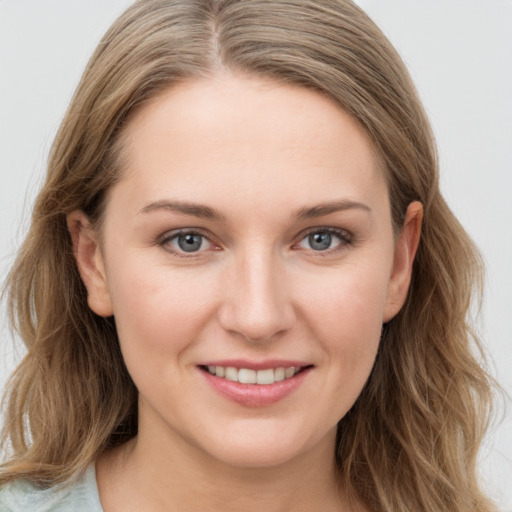 Joyful white young-adult female with long  brown hair and grey eyes